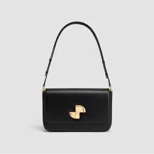 Patou Le Lock Shoulder Bag is a black calf leather